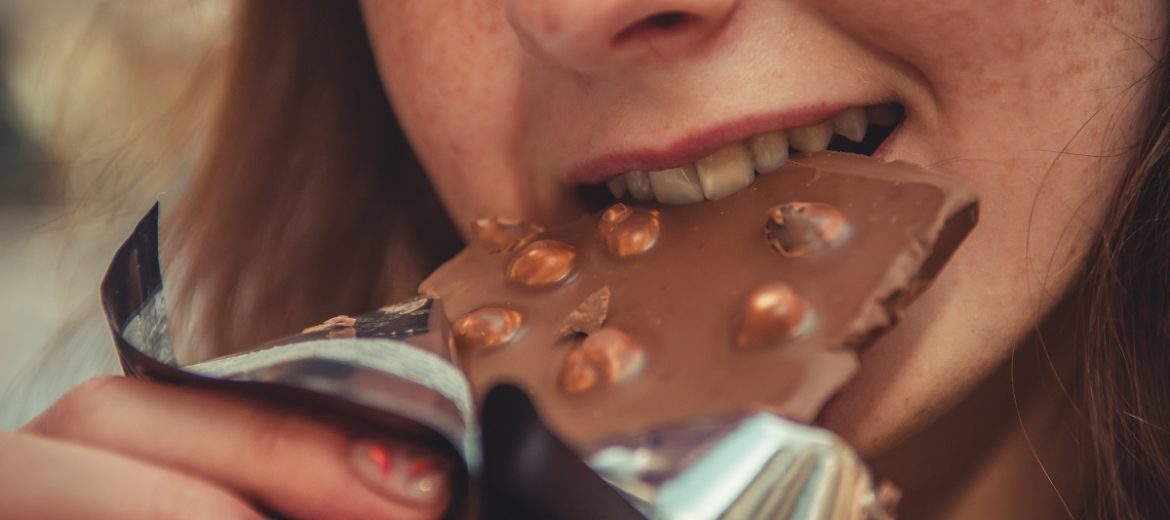 woman eating chocolate Naomi Judge Naturopath Nutritionist is sugar making you miserable